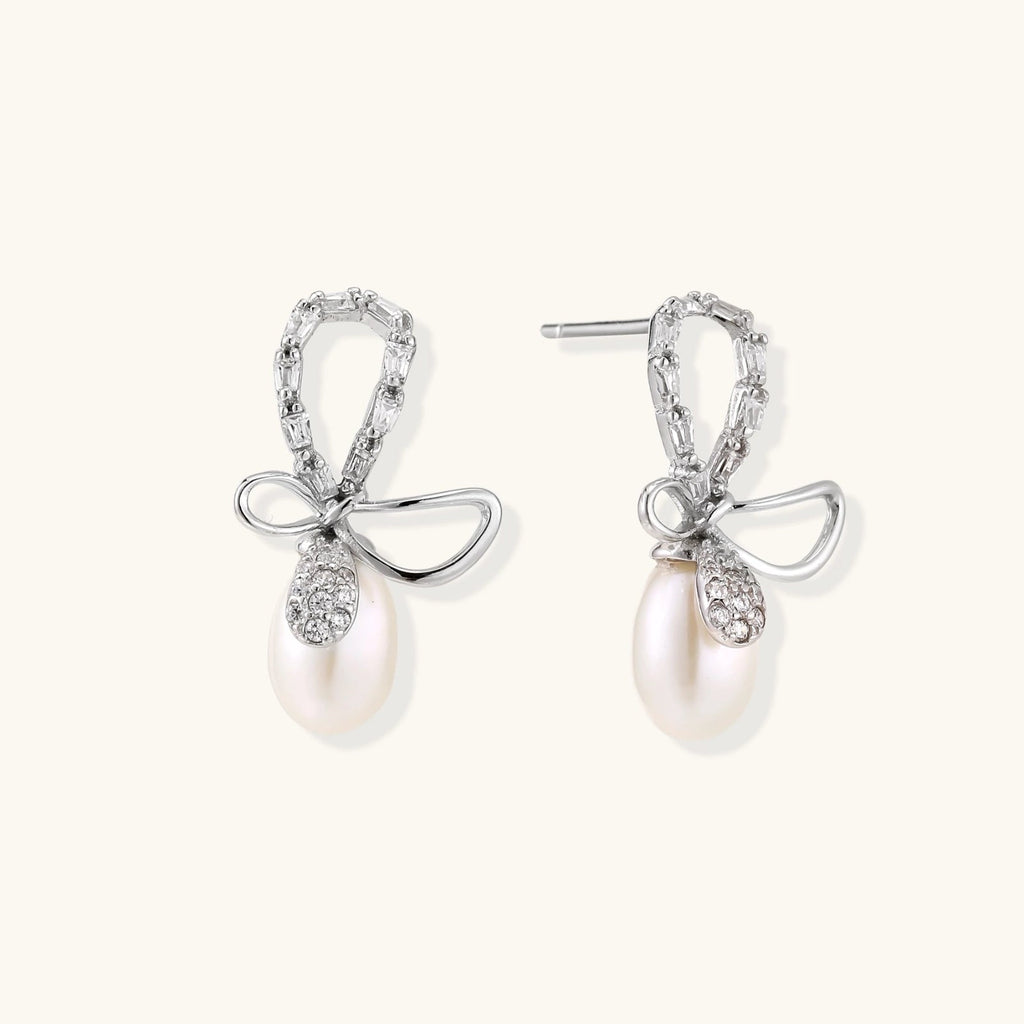 Anointed Garments Crystal Bow Pearl Drop earrings in rhodium-plated sterling silver with baguette-cut crystal accents.