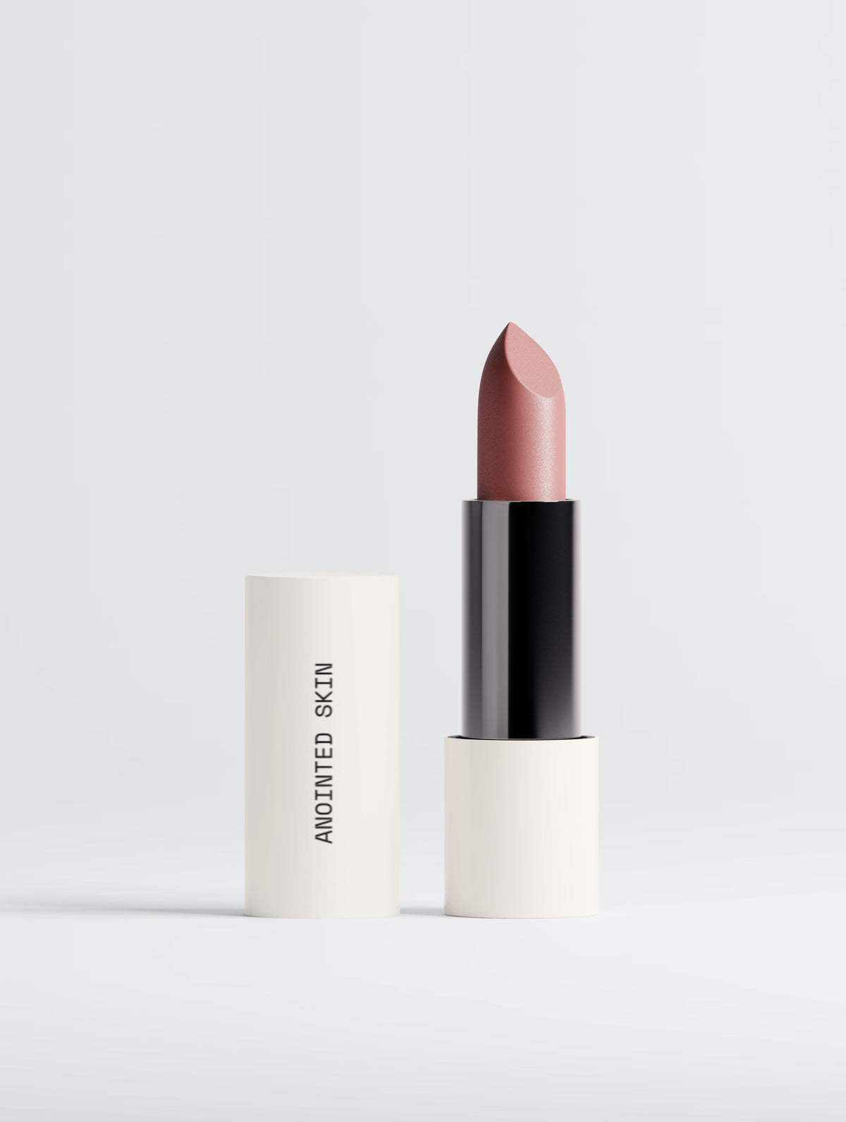 Anointed Garments Anointed Skin Matte Lipstick in Dusty Rose with a creamy, velvety satin finish in a white tube.