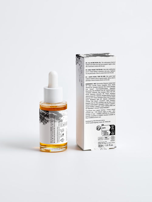 Anointed Garments All-In-One Facial Oil in a glass dropper bottle next to its white and black product packaging box.