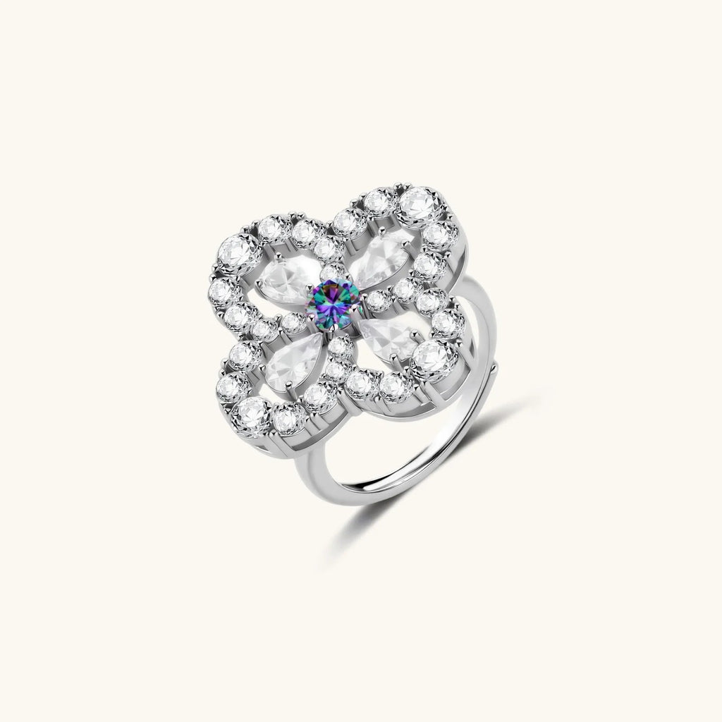 Anointed Garments floral moissanite ring in platinum-plated sterling silver with a round center stone and petal design.