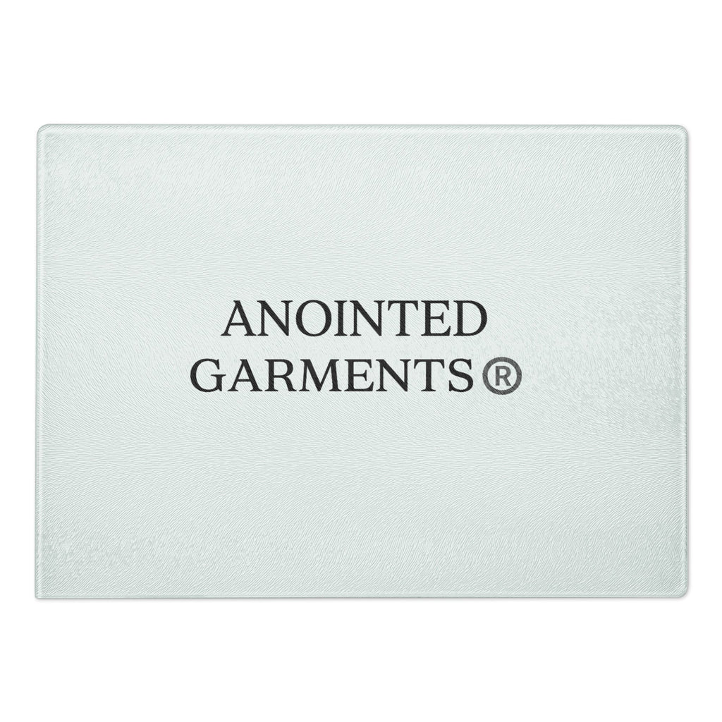 Anointed Garments tempered glass cutting board with a textured surface and centered brand logo.
