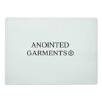 Anointed Garments tempered glass cutting board with a textured surface and centered brand logo.
