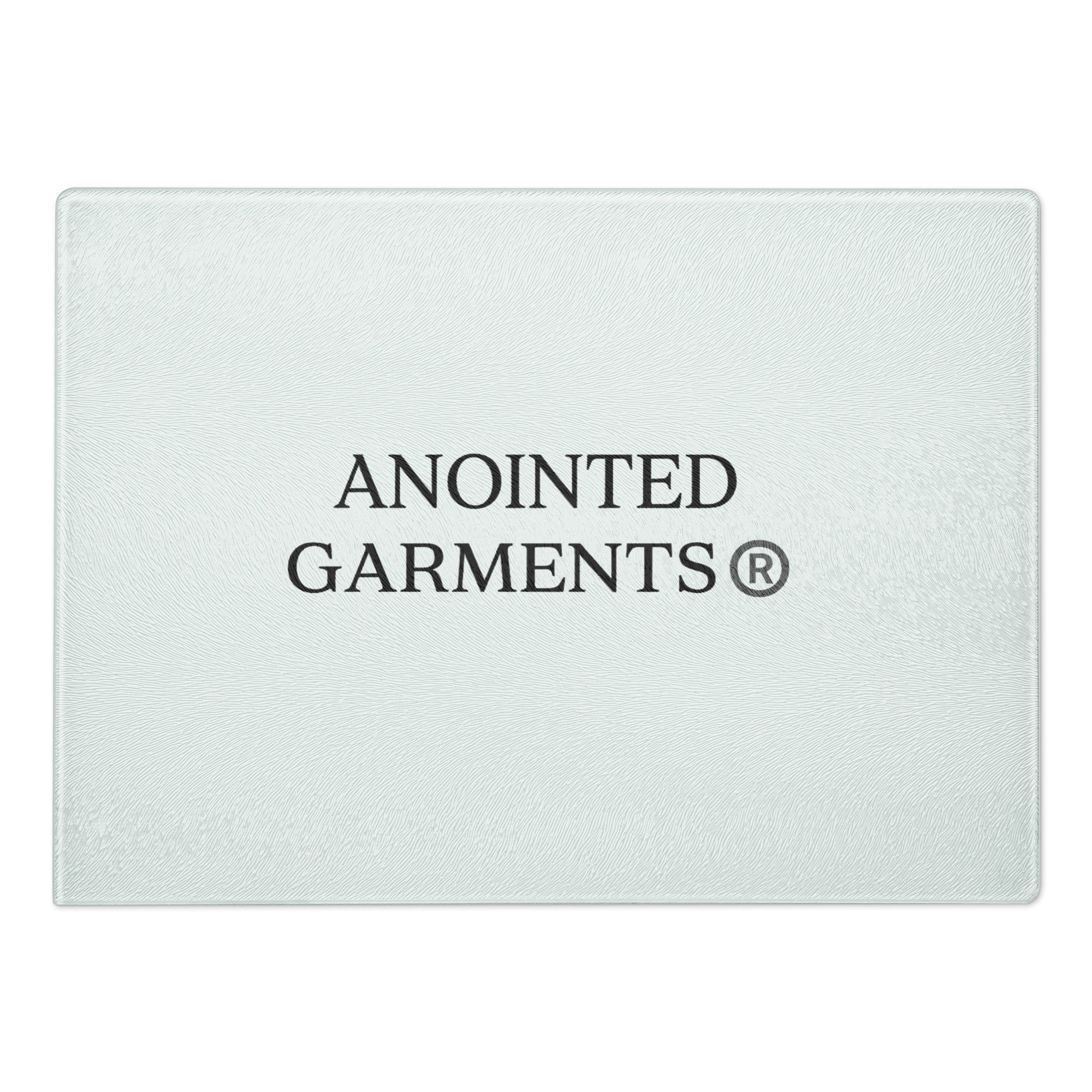 Anointed Garments tempered glass cutting board with a textured surface and centered brand logo.