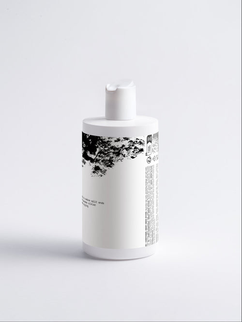 Anointed Garments Gloss Conditioner in a white bottle with smoky green vetiver scent for silky hair and split ends.