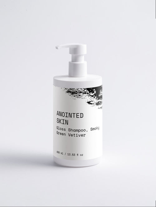 Anointed Garments Gloss Shampoo in a white pump bottle with Smoky Green Vetiver label for smooth, glossy hair.