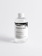 Anointed Garments Anointed Skin 5% Glycolic Acid liquid exfoliator toner in a clear bottle with a white cap.