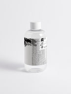 Anointed Garments Glycolic Acid Liquid Exfoliator in a clear bottle with a white cap against a plain white background.