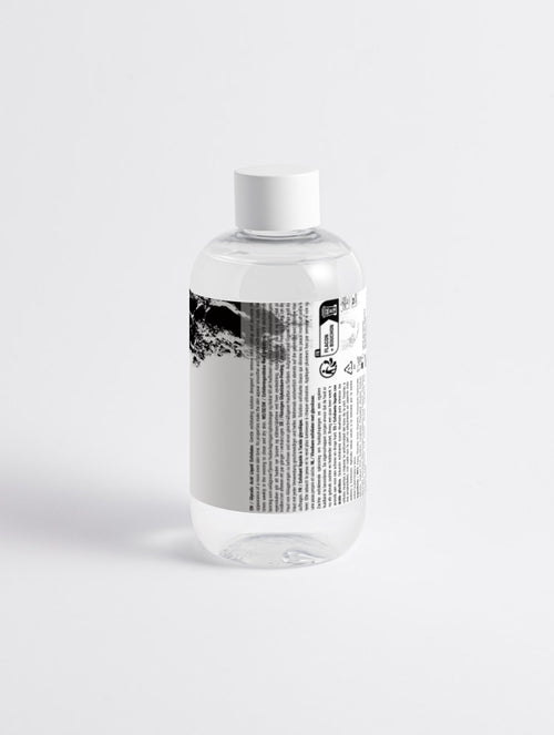 Anointed Garments Glycolic Acid exfoliating toner in a clear bottle with a white cap on a white background.
