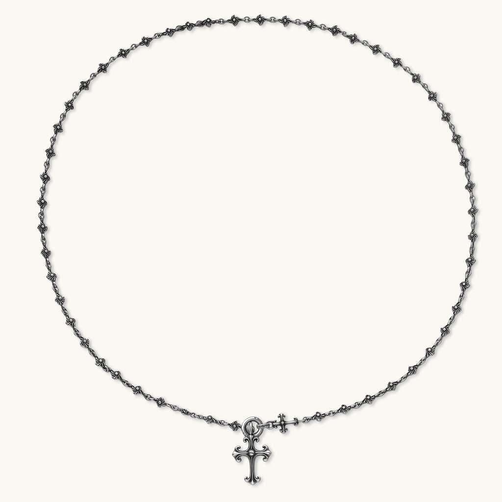 Anointed Garments sterling silver gothic cross necklace with an ornate fleur-de-lis pendant and oxidized floral chain.