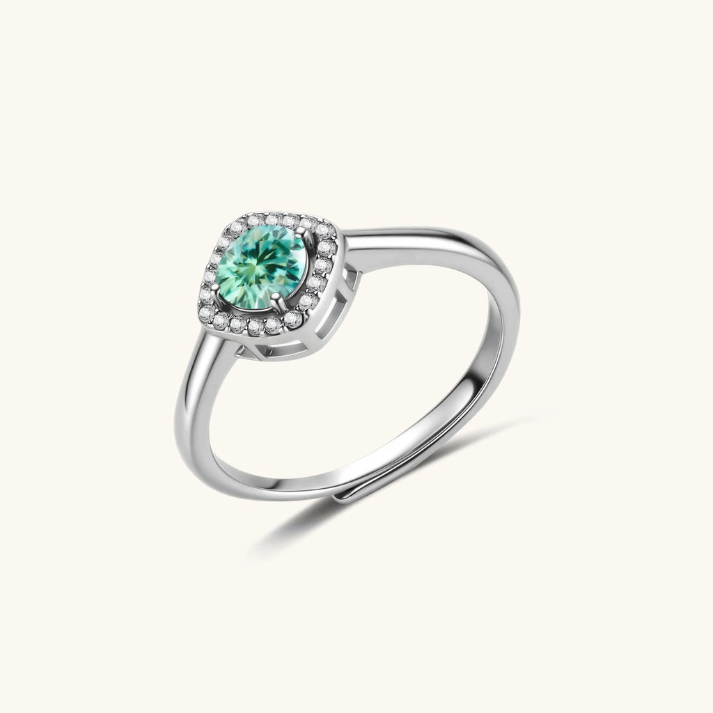 Anointed Garments Emerald Glow halo ring featuring a round green moissanite in a platinum-plated sterling silver setting.