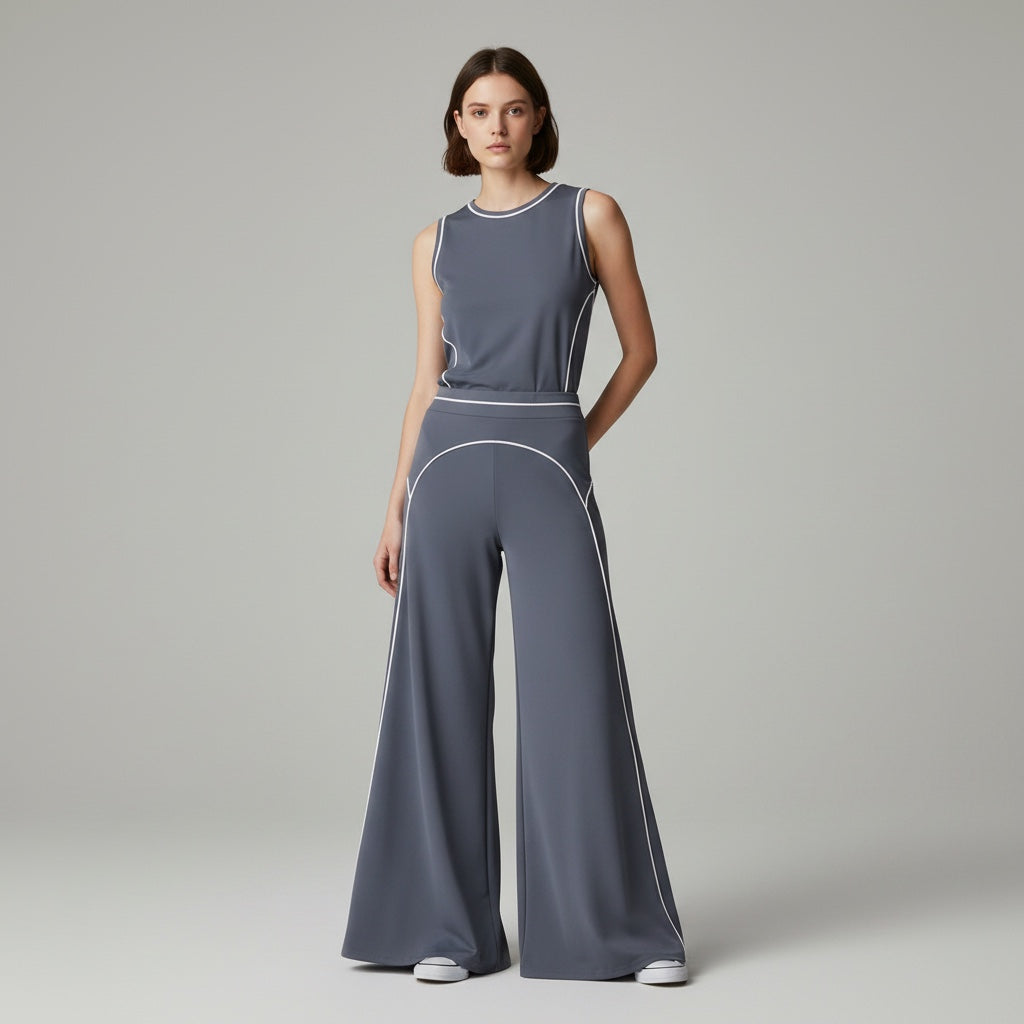 Anointed Garments grey high-waisted wide-leg trousers with white contrast piping worn with a matching sleeveless top