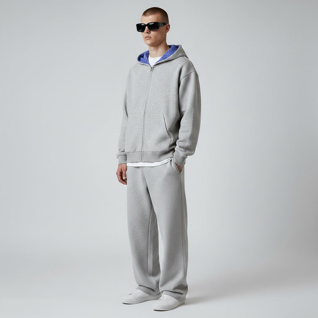 Model wearing Anointed Garments grey heavyweight cotton full zip hoodie with blue patterned hood lining and sweatpants