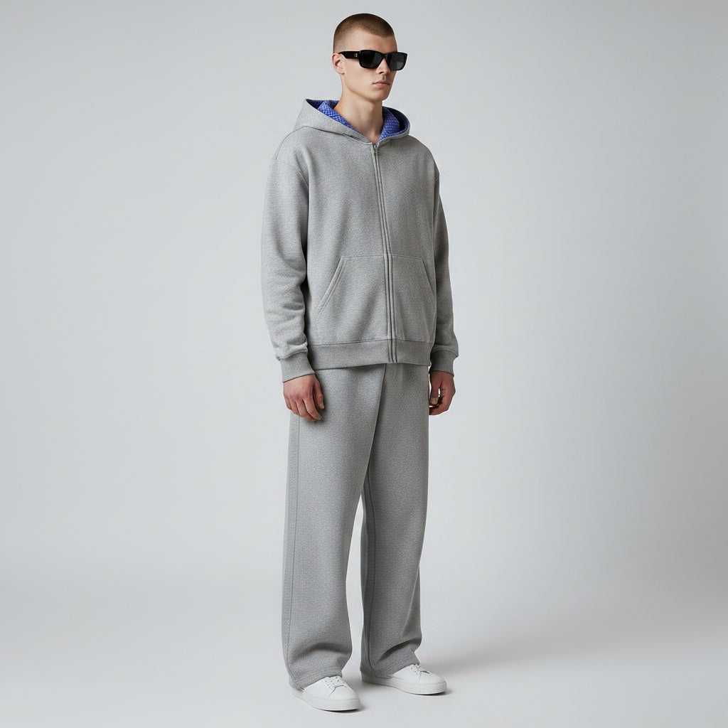 Model wearing Anointed Garments grey heavyweight cotton full zip hoodie with blue patterned hood lining and sweatpants