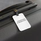Anointed Garments hardshell suitcase featuring a white luggage tag with the brand logo attached to the handle.