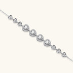 Anointed Garments heart-shaped moissanite bracelet in platinum-plated sterling silver with delicate link chain.