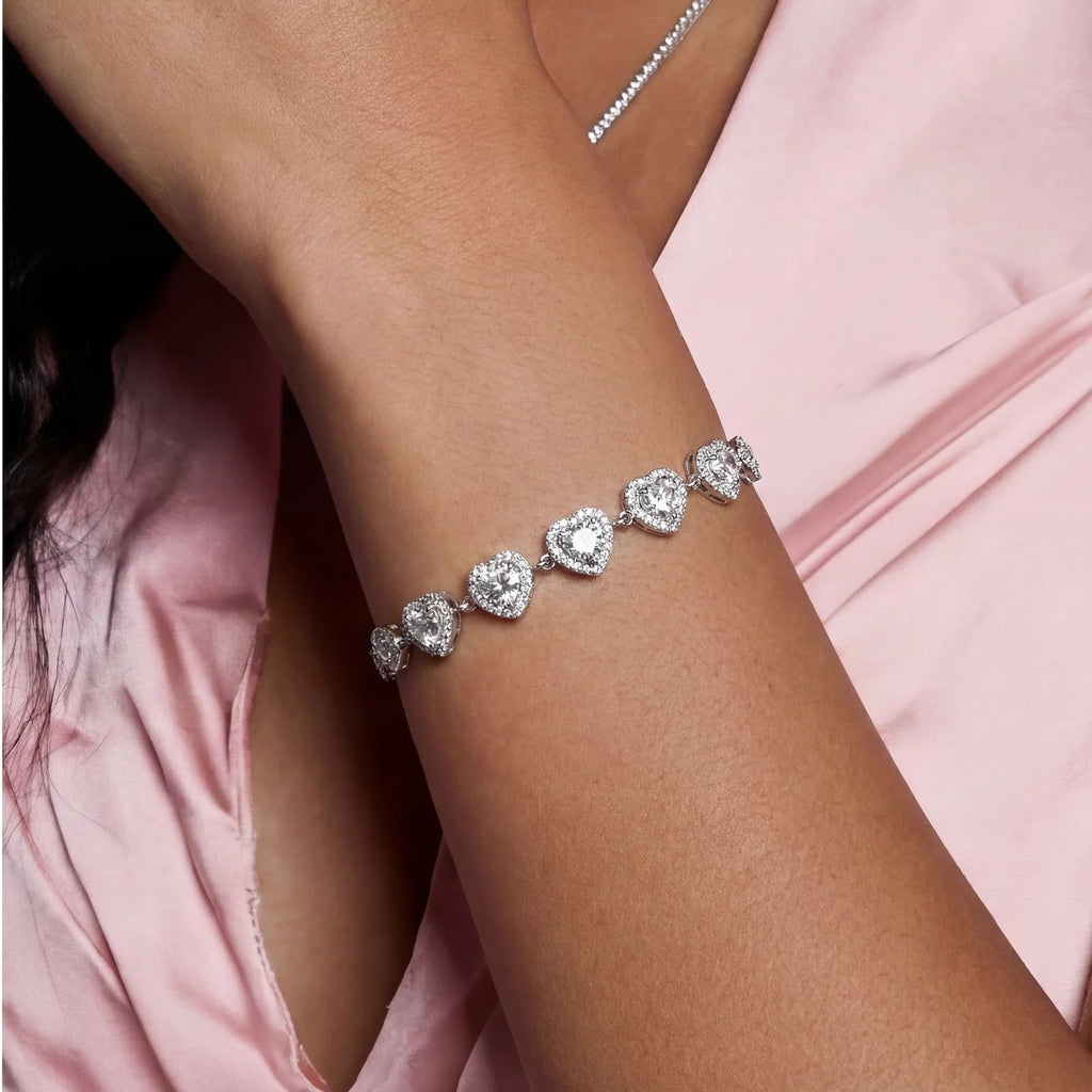Anointed Garments heart-shaped moissanite bracelet in platinum-plated sterling silver worn on a model's wrist.