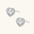 Anointed Garments heart-shaped moissanite stud earrings in platinum-plated 925 sterling silver with a halo setting.