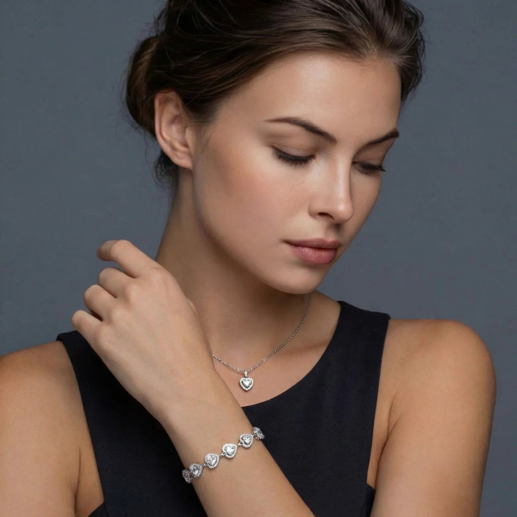 Anointed Garments heart moissanite necklace and bracelet set on a model wearing a black top against a grey background.
