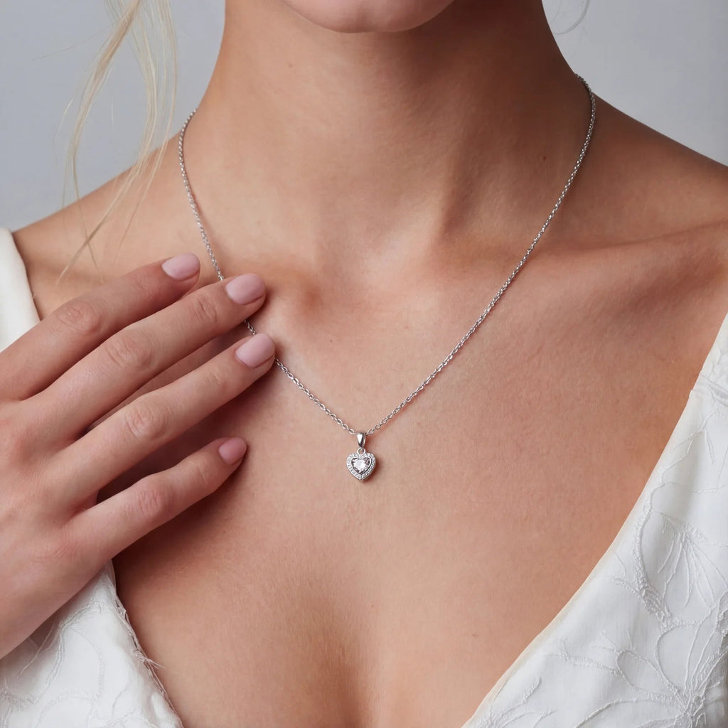 Anointed Garments heart-shaped moissanite pendant necklace in platinum-plated sterling silver worn by a woman