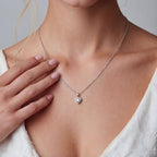 Anointed Garments heart-shaped moissanite pendant necklace in platinum-plated sterling silver worn by a woman