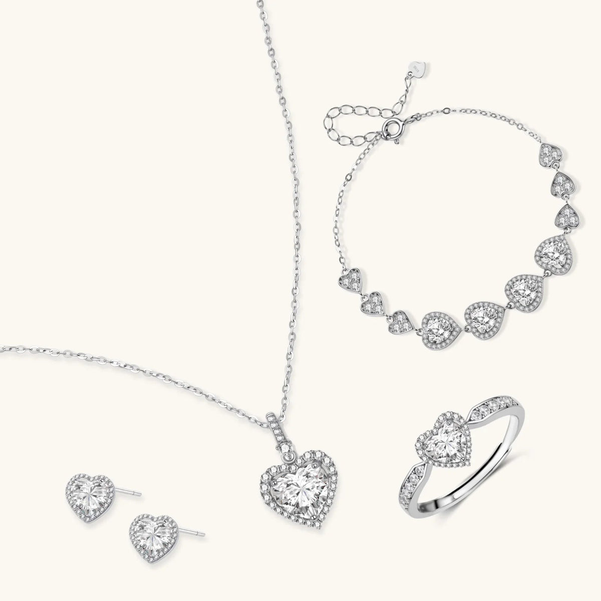 Anointed Garments Heart Symphony moissanite jewelry set featuring a necklace, earrings, ring, and bracelet in silver.