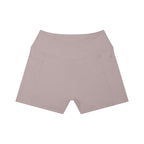 Anointed Garments high-rise yoga shorts in a soft mauve tone, featuring a crossover waistband and side pockets.