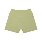 Anointed Garments high-rise yoga shorts in light olive green with side pockets and a flattering crossover waistband.