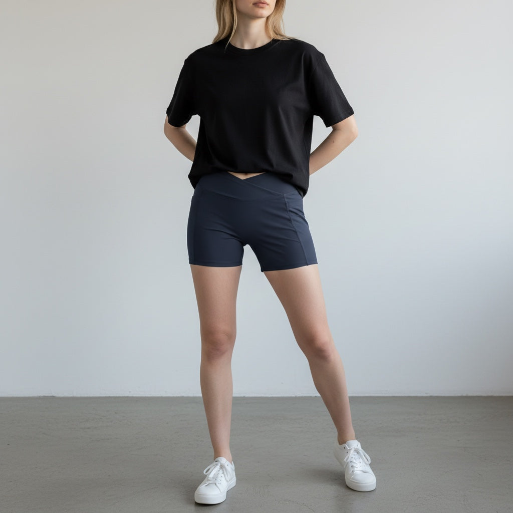 Anointed Garments high-waisted athletic performance shorts in dark blue with a crossover waistband and side pockets.