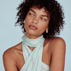 Anointed Garments Infinity Pearl Studs featuring rhodium-plated sterling silver twists and freshwater pearls on model