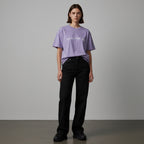 Anointed Garments lavender mineral-wash cotton t-shirt with Pray For Me graphic worn by a model with black jeans