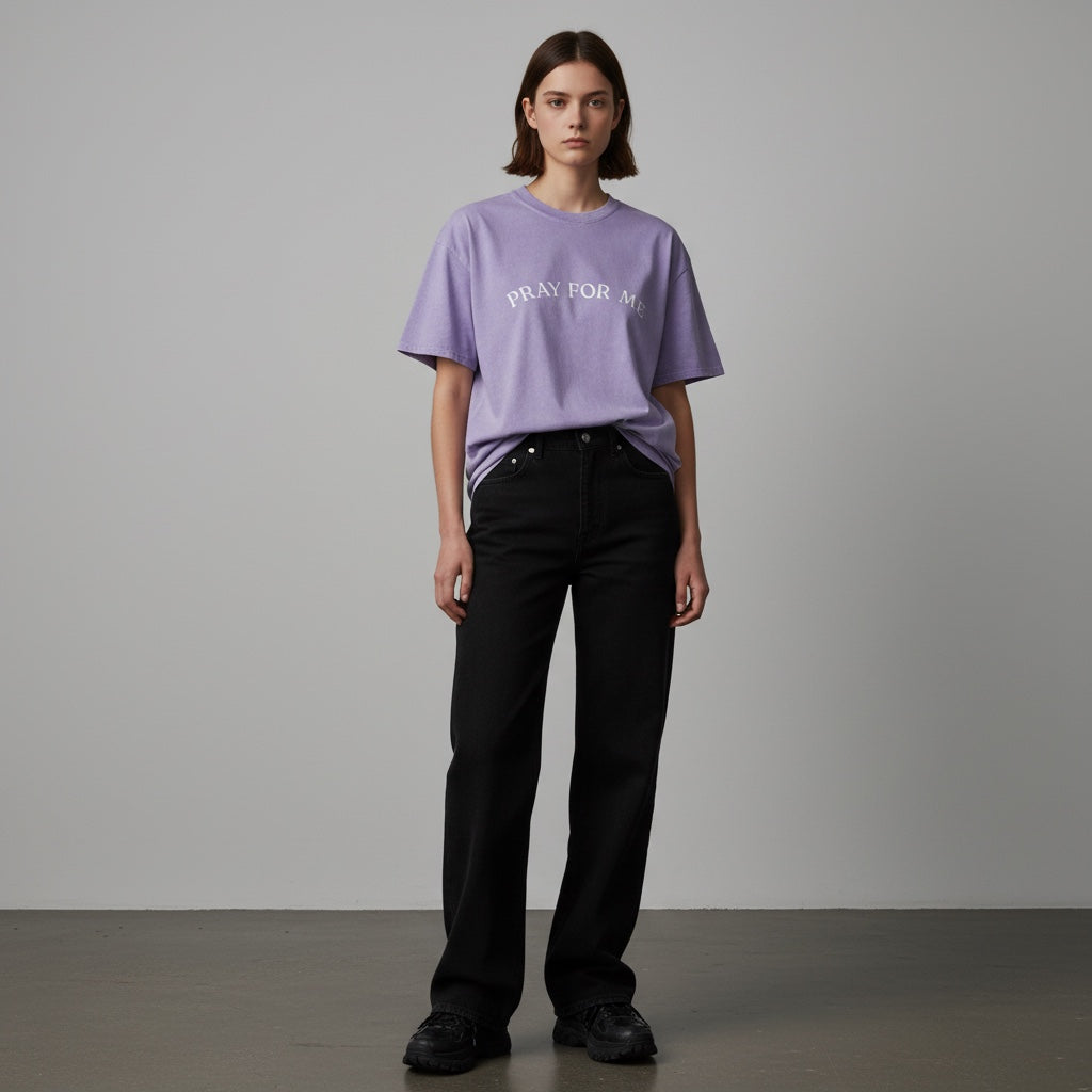 Anointed Garments lavender mineral-wash cotton t-shirt with Pray For Me graphic worn by a model with black jeans