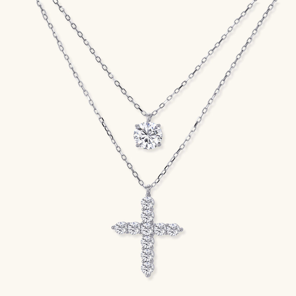 Anointed Garments layered necklace set featuring a round moissanite pendant and a cross pendant in platinum-plated silver