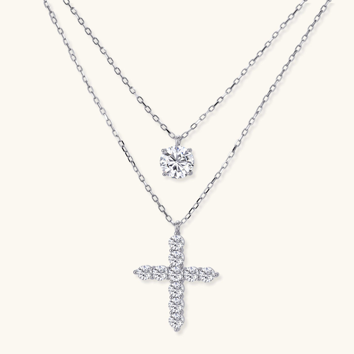 Anointed Garments layered necklace set featuring a round moissanite pendant and a cross pendant in platinum-plated silver