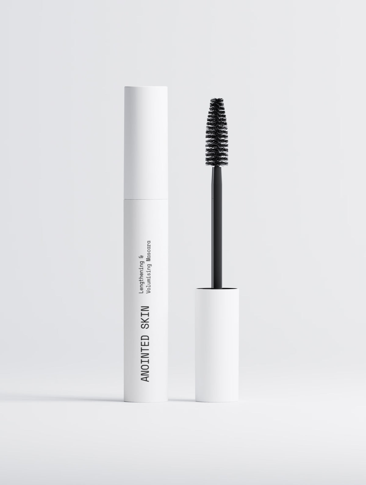 Anointed Garments Anointed Skin lengthening and volumizing mascara in a white tube with a black applicator brush.