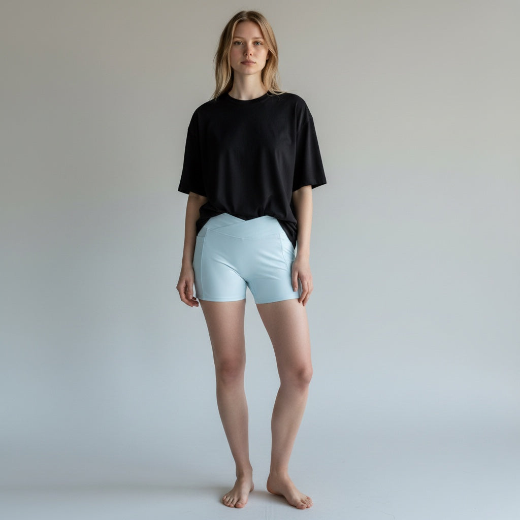 Anointed Garments light blue high-waisted athletic performance shorts with side pockets worn by a blonde model.