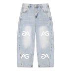 Anointed Garments light-wash relaxed fit denim jeans with a repeating white AG logo print and distressed details.