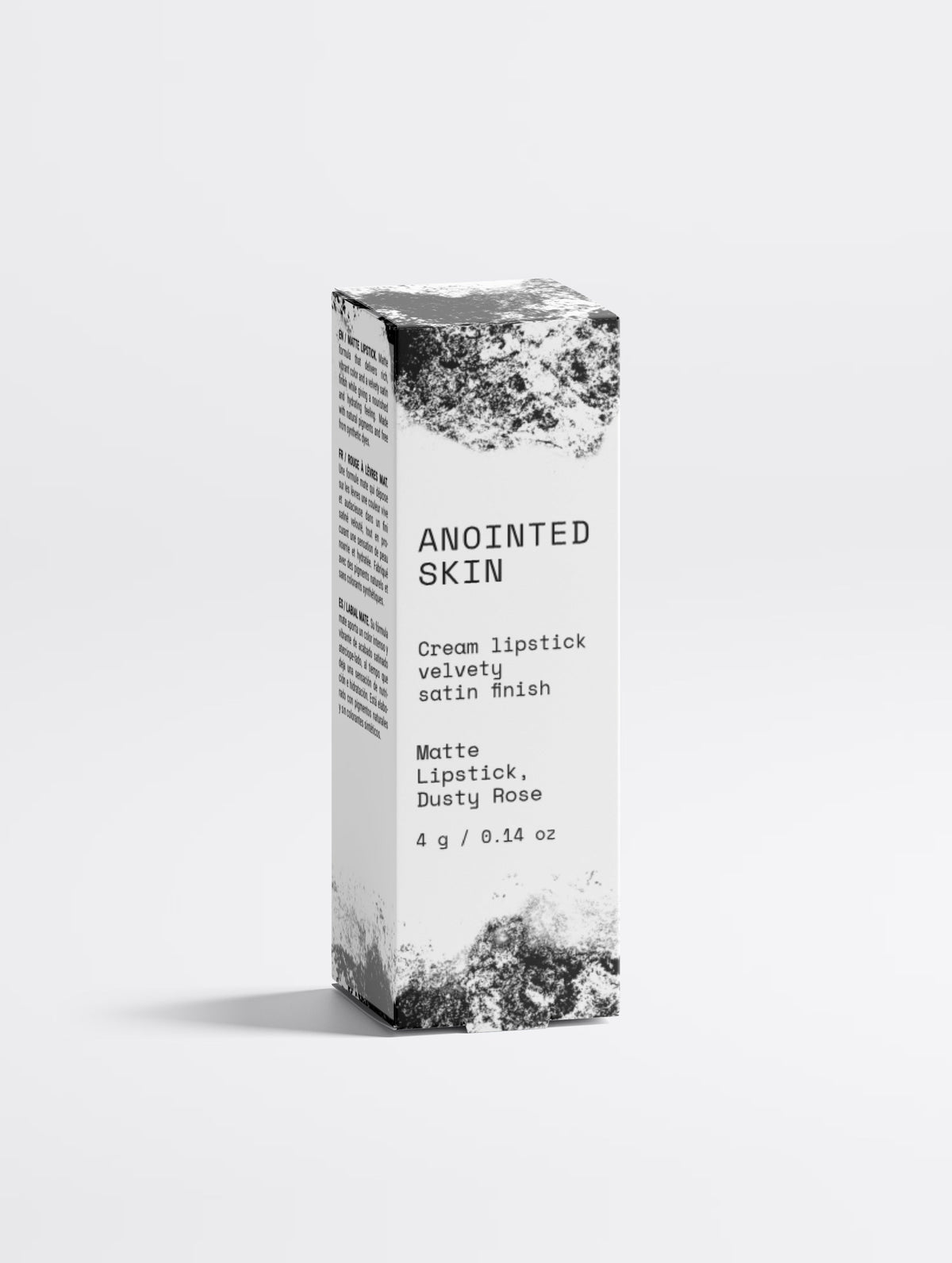 Anointed Garments Anointed Skin Matte Lipstick in Dusty Rose packaging with a white and black textured design.