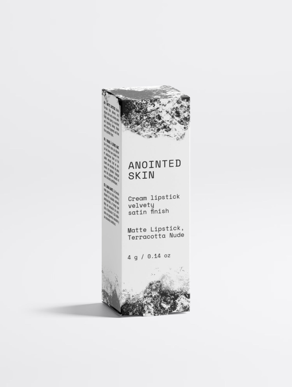 Anointed Garments Anointed Skin Matte Lipstick in Terracotta Nude packaging box with black and white artistic design