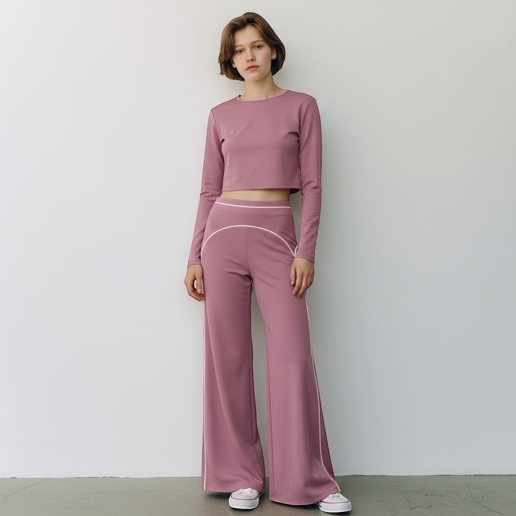 Anointed Garments mauve high-waisted wide-leg trousers with white contrast piping worn by a woman in a matching crop top