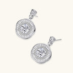 Anointed Garments celestial sunburst drop earrings in platinum-plated sterling silver with round-cut moissanite stones.