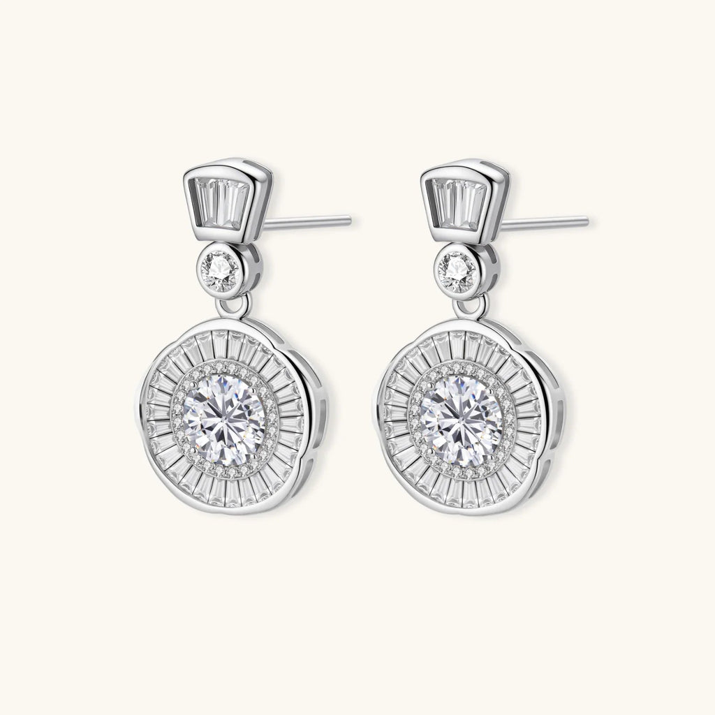 Anointed Garments celestial sunburst drop earrings in platinum-plated sterling silver with round-cut moissanite stones.
