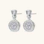 Anointed Garments celestial sunburst drop earrings in platinum-plated sterling silver with round-cut moissanite stones.
