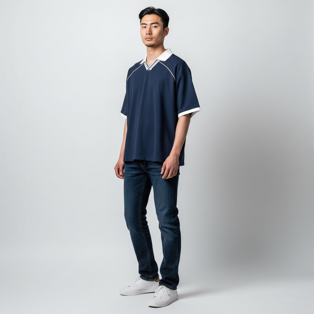Anointed Garments unisex navy blue boxy soccer jersey with white piping, lapel collar, and drop shoulders on a model.