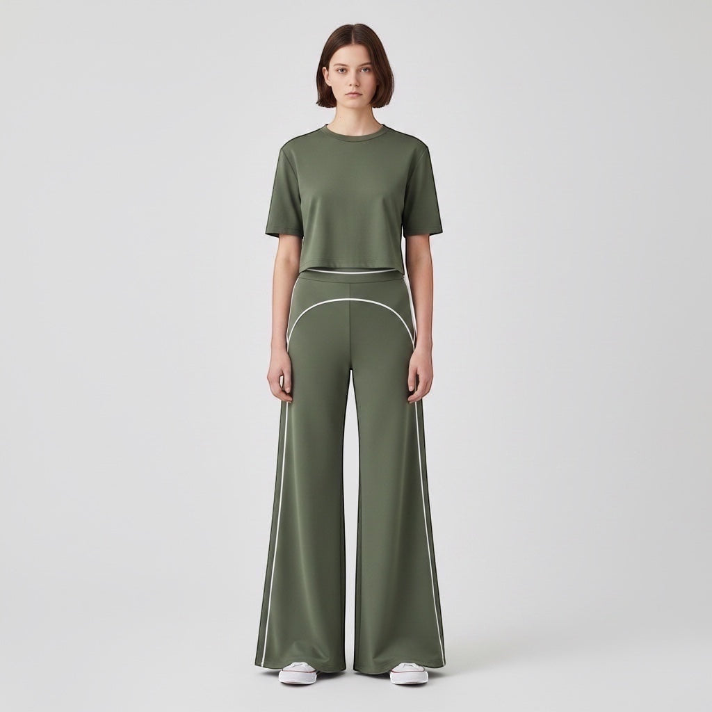Model wearing Anointed Garments olive green high-waisted wide-leg trousers with white contrast piping and matching top
