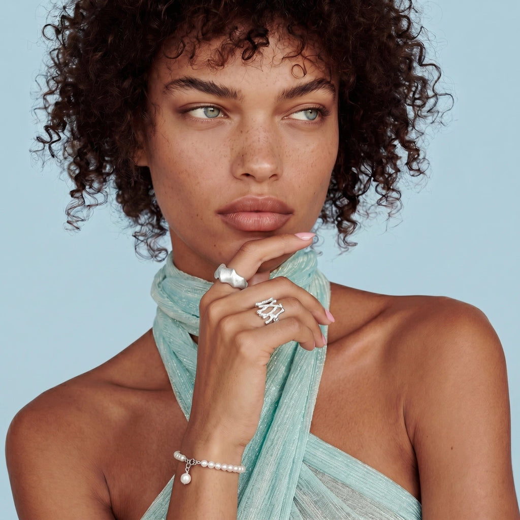 Anointed Garments Pearlescent Dreams Bracelet featuring freshwater pearls and a silver pendant worn by a model.