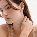 Anointed Garments Pearl Halo Studs featuring a round freshwater pearl in a square rhodium-plated sterling silver frame.