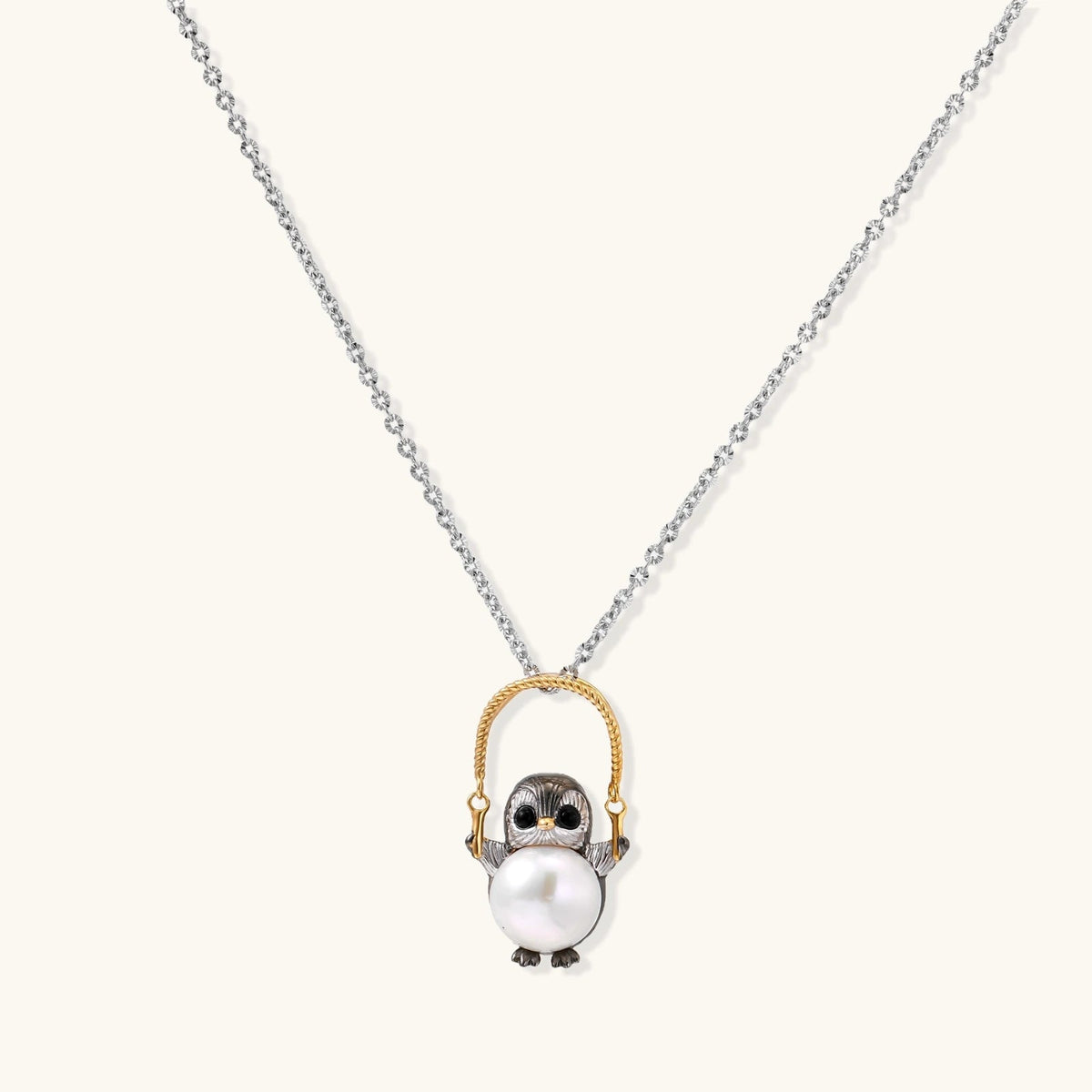 Anointed Garments Wise Penguin Pearl Necklace featuring a sterling silver penguin pendant holding a freshwater pearl.