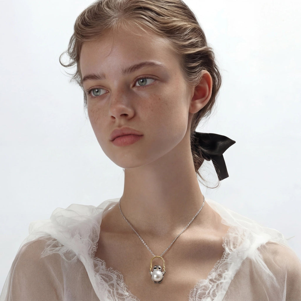 Anointed Garments Wise Penguin Pearl Necklace featuring a sculptural penguin pendant with a freshwater pearl on a chain