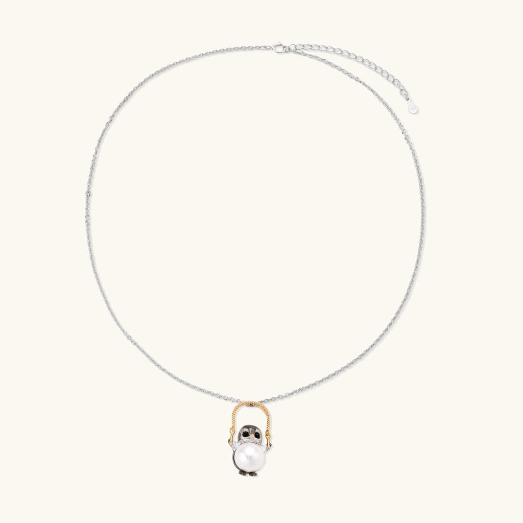 Anointed Garments Wise Penguin necklace featuring a sculptural penguin pendant holding a 9.8mm freshwater pearl.