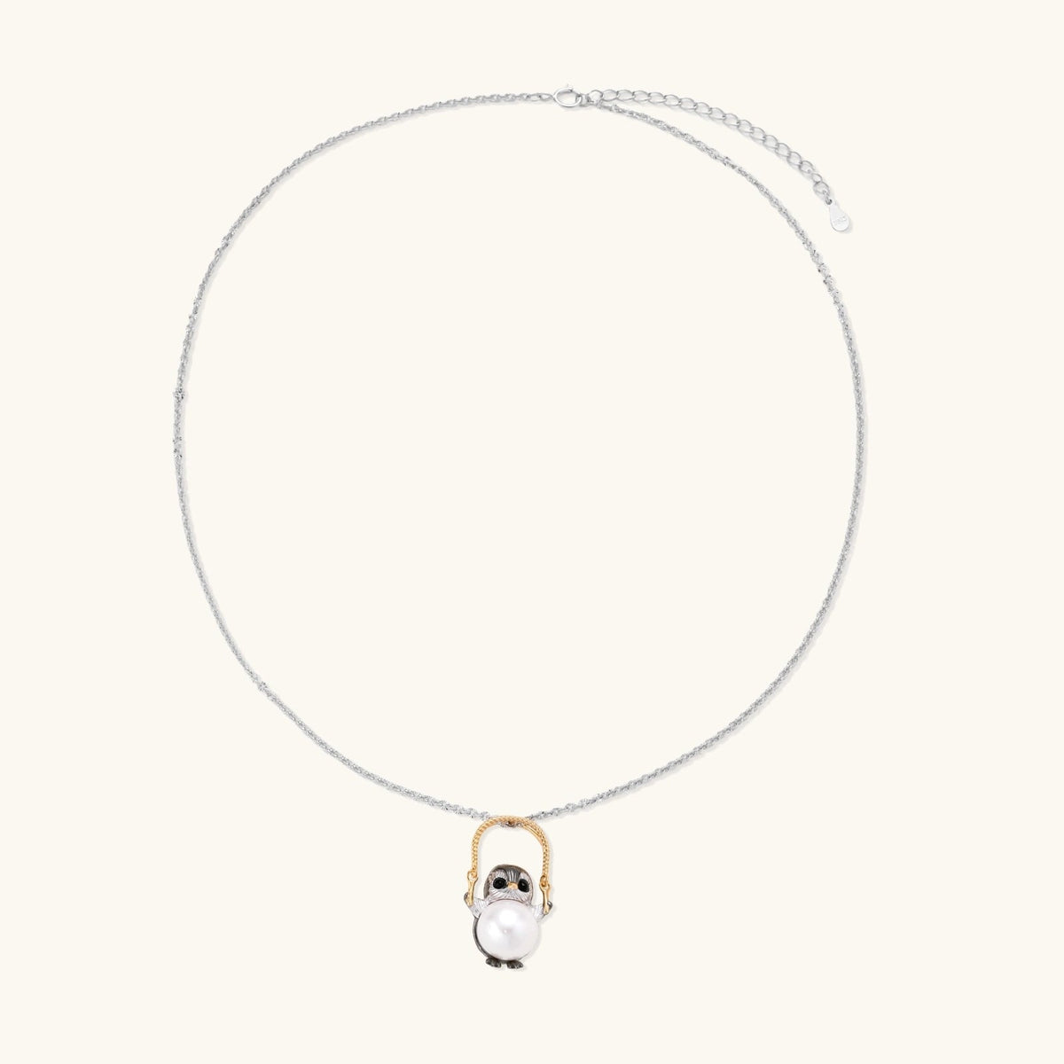 Anointed Garments Wise Penguin necklace featuring a sculptural penguin pendant holding a 9.8mm freshwater pearl.